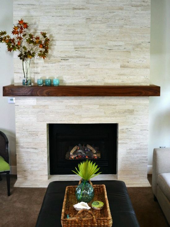 a living room with a couch, coffee table and fireplace