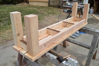 a wooden bench being built in the yard