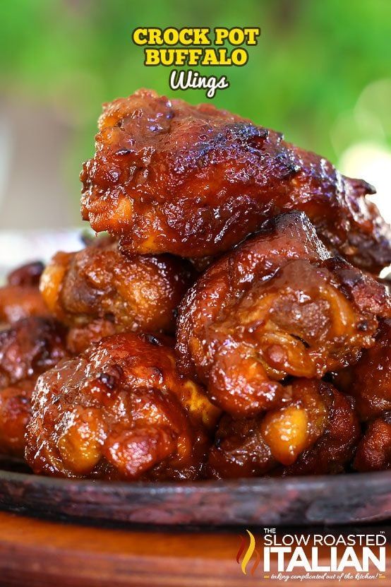 some food is piled on top of each other in a bowl with the words crock pot buffalo wings above it