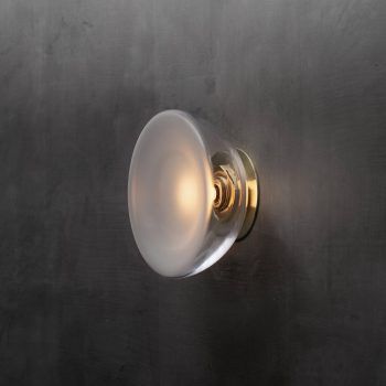 a light that is on the side of a metal wall with a white ball hanging from it