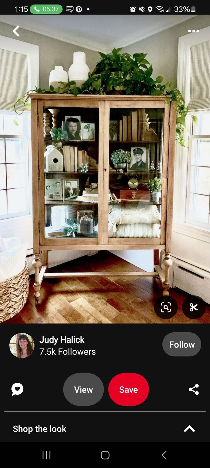 a wooden cabinet with glass doors and shelves