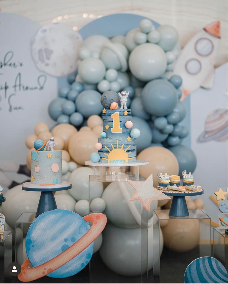 a space themed birthday party with balloons and cake