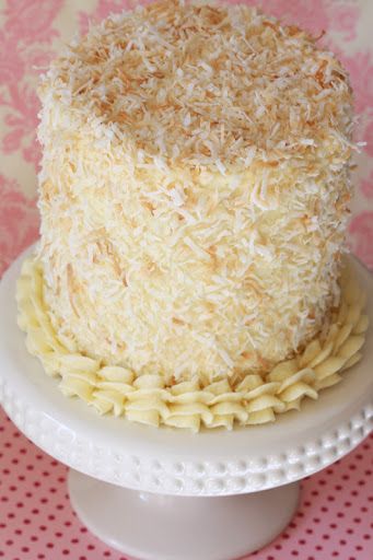 a close up of a cake on a plate with pink and white table cloth in the background