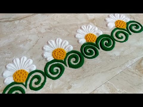 some white and yellow flowers on a marble floor with green trimmings around them