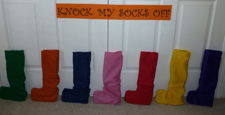 colorful boots are lined up in front of a sign that says knock my socks off