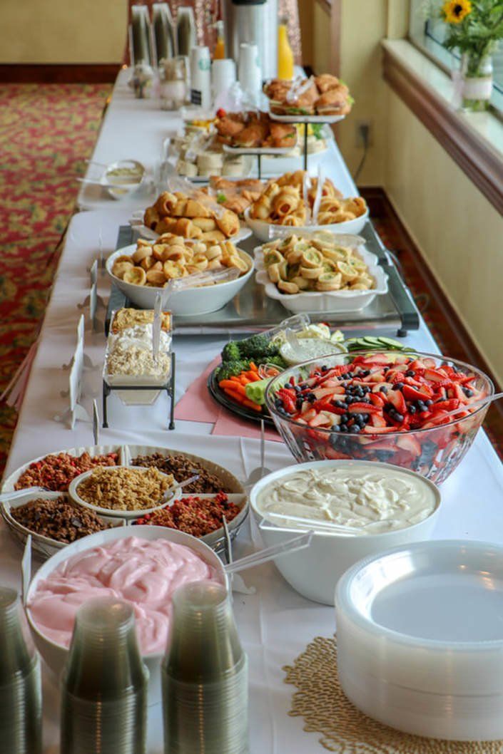 a long table filled with lots of different foods and desserts on top of it