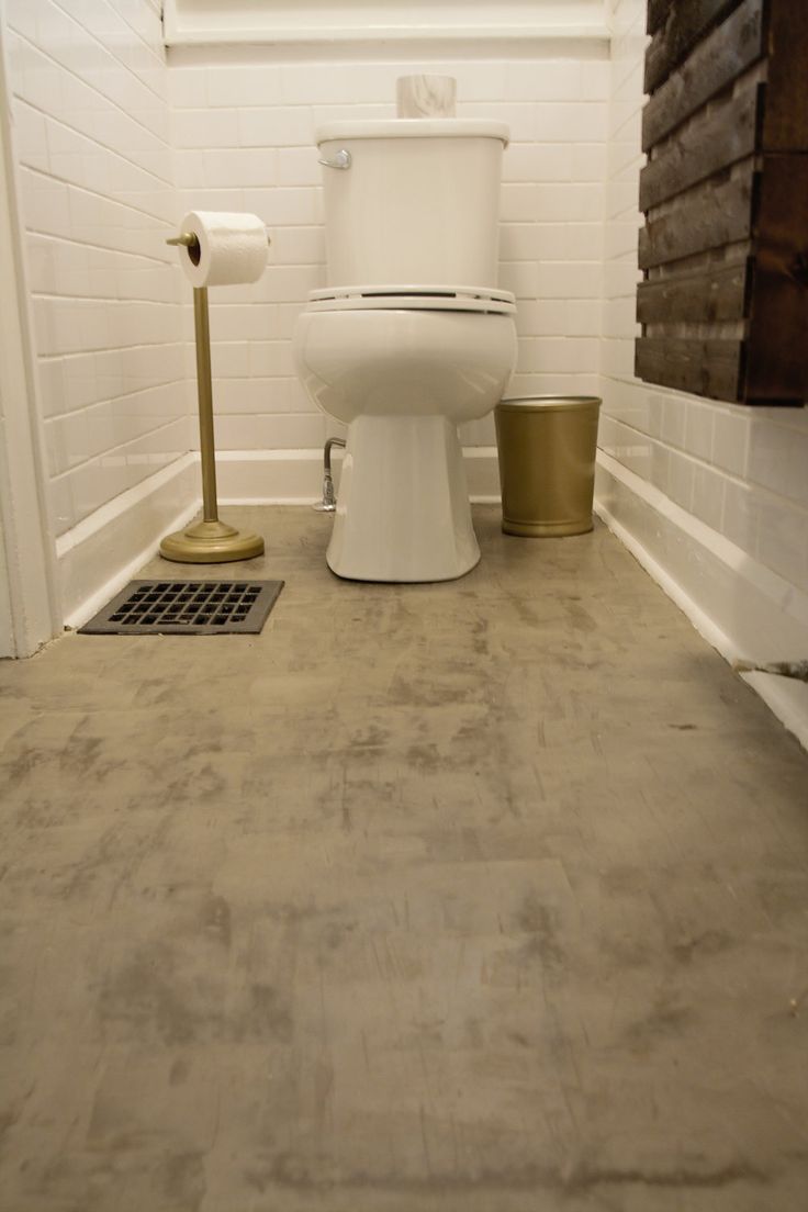 a white toilet sitting in a bathroom next to a trash can