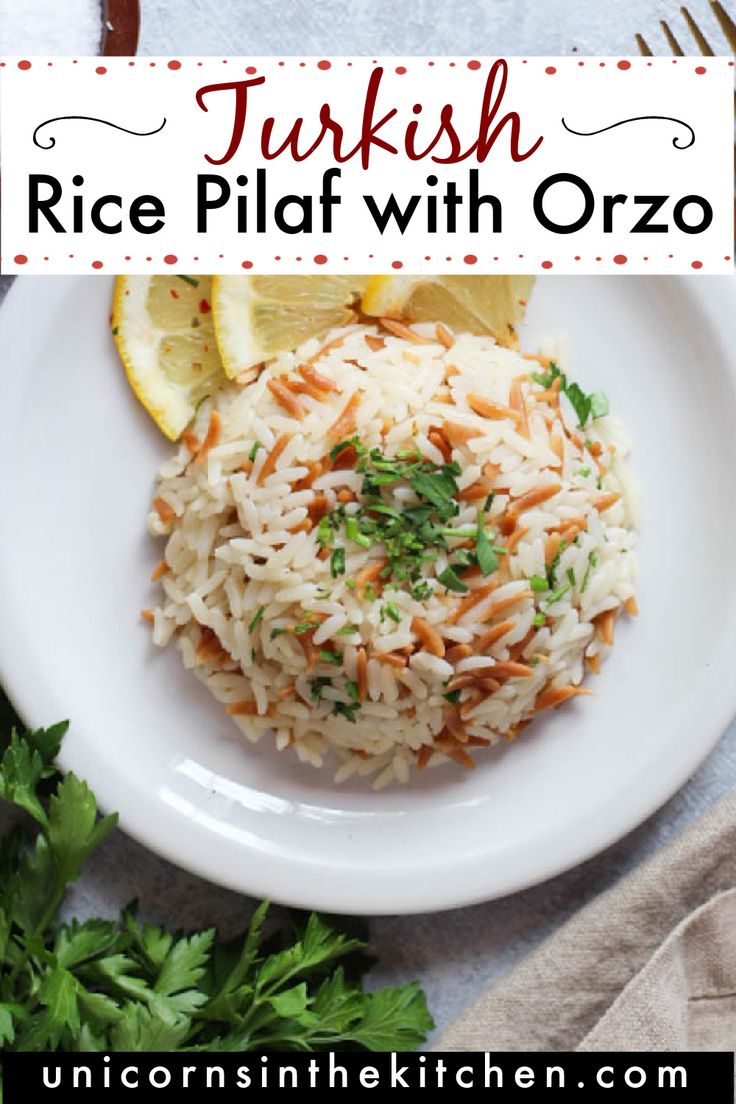 a white plate topped with rice and garnished with parsley next to lemon wedges