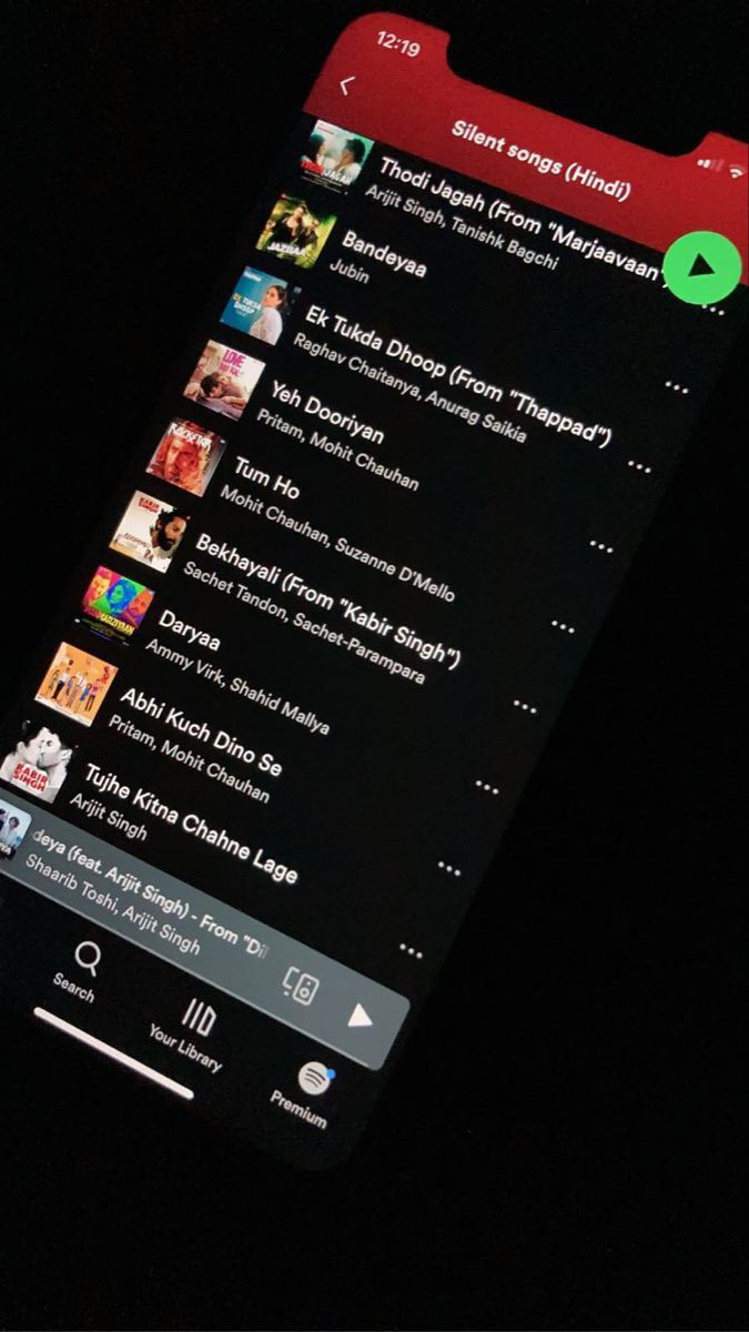 an image of a cell phone screen with music player on the bottom right corner and other audio players in the background