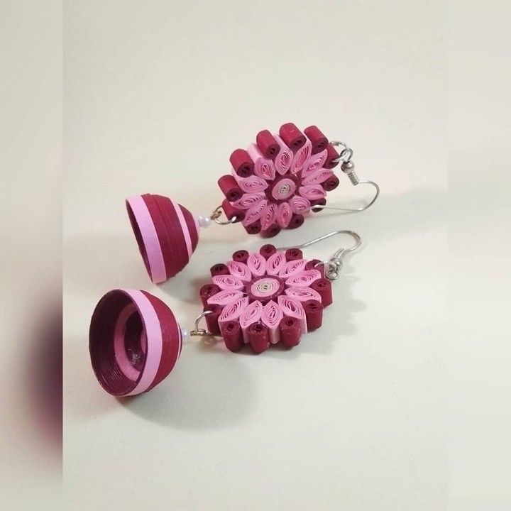 two pink and white flower earrings with matching earring hooks on a white table top