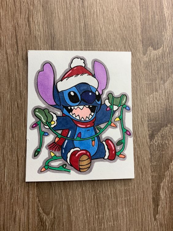 a sticker with an image of stitchy in a santa hat on it's head