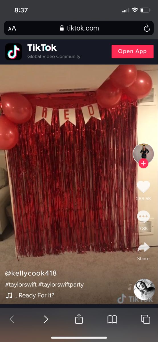 a red curtain and some balloons in the room