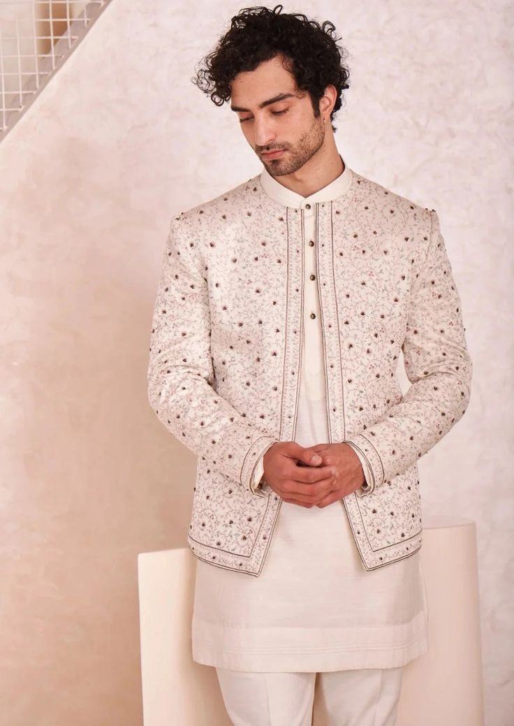 Featuring kashmiri jamawar hand embroidered short jacket. Paired with short kurta and tapered trousers. Fitted Off White Nehru Jacket With Chikankari Embroidery, Fitted Off-white Nehru Jacket With Chikankari Embroidery, Traditional Off White Nehru Jacket With Naqshi, Festive White Outerwear With Chikankari Embroidery, Off White Long Sleeve Nehru Jacket With Naqshi, Off White Long Sleeve Sherwani With Naqshi, Beige Long Sleeve Bandhgala With Chikankari Embroidery, Festive Bandhgala With Intricate Embroidery And Stand Collar, White Festive Transitional Outerwear