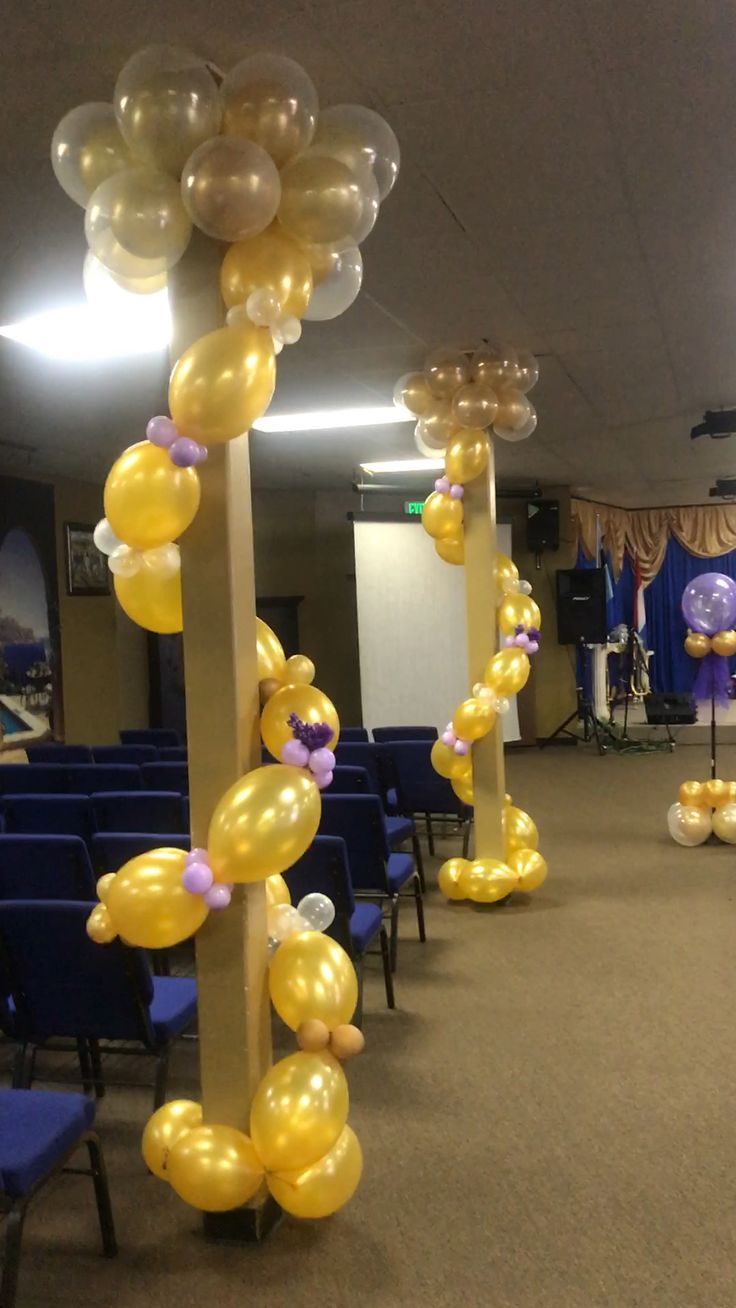 balloons are attached to pillars in an empty room