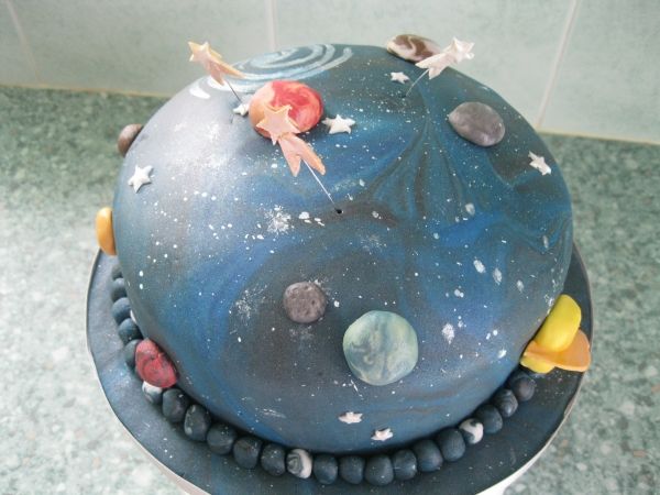 a space themed cake with planets and stars on it