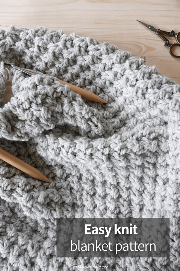 an easy knit blanket pattern with scissors and yarn