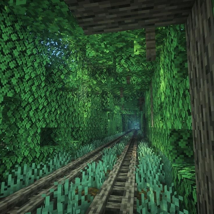 the inside of a minecraft tunnel with lots of green plants and trees on either side