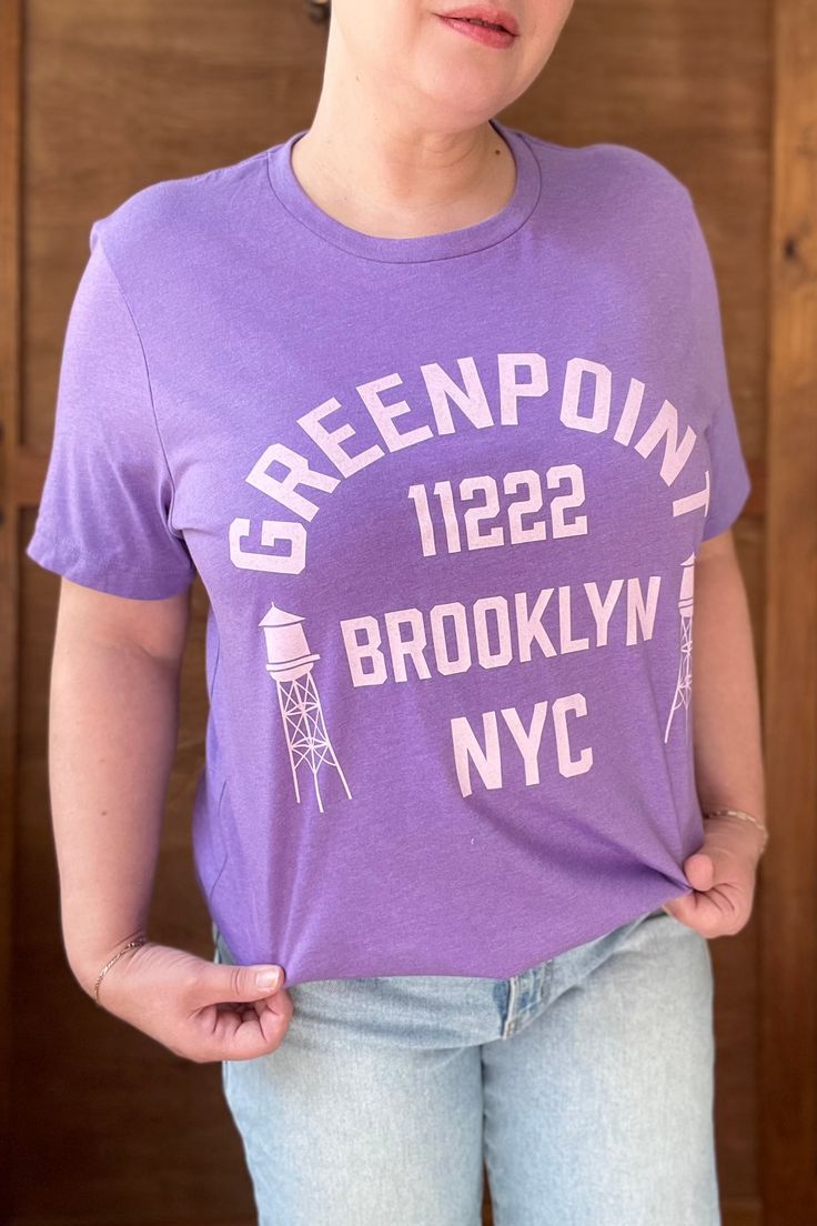 *Orders placed after December 11 are not guaranteed to arrive by Christmas* *Online only. This tee will be printed specially for you and may ship separately from other items in your order. Ships within a few days* What’s comfier than a casual tee? A premium casual tee. Rep your favorite neighborhood in this unisex Greenpoint jersey t-shirt. It features a crew neck, short sleeves and a new modern relaxed fit for effortless style. Design is exclusive to Local Color NYC. Solid colors are 100% cotto Trendy Purple T-shirt With Logo Print, Purple Crew Neck Top With Letter Print, Purple Letter Print Crew Neck Top, Sporty Purple T-shirt With Graphic Print, Purple Crew Neck Top With Text Print, Purple Crew Neck T-shirt For Everyday, Everyday Purple Crew Neck T-shirt, Purple Short Sleeve T-shirt For Everyday, Everyday Crew Neck T-shirt With Screen Print