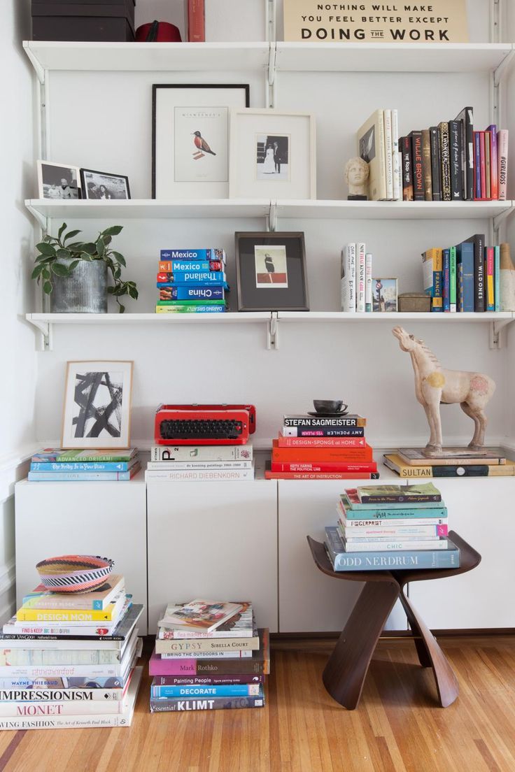 the bookshelf is filled with many different types of books and magazines on it