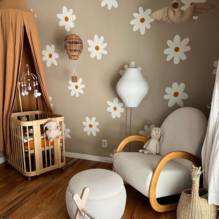 a baby's room with flowers on the wall and a crib in the corner