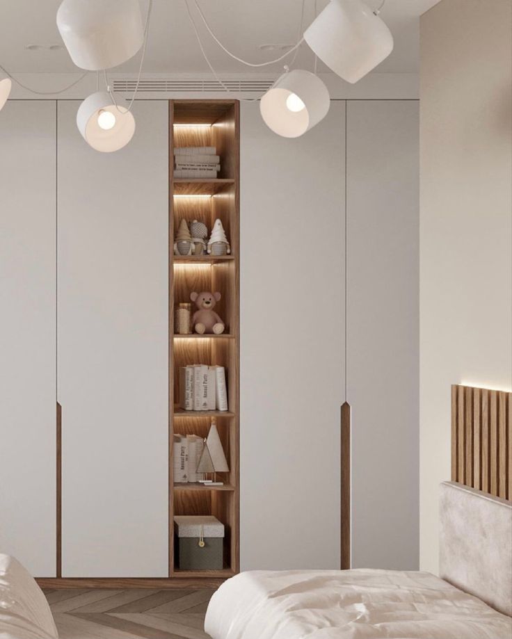 a bedroom with white walls and wooden shelves