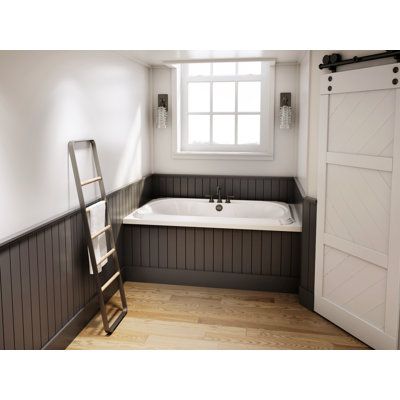 an empty bathroom with a ladder leaning against the wall and a bathtub in the corner