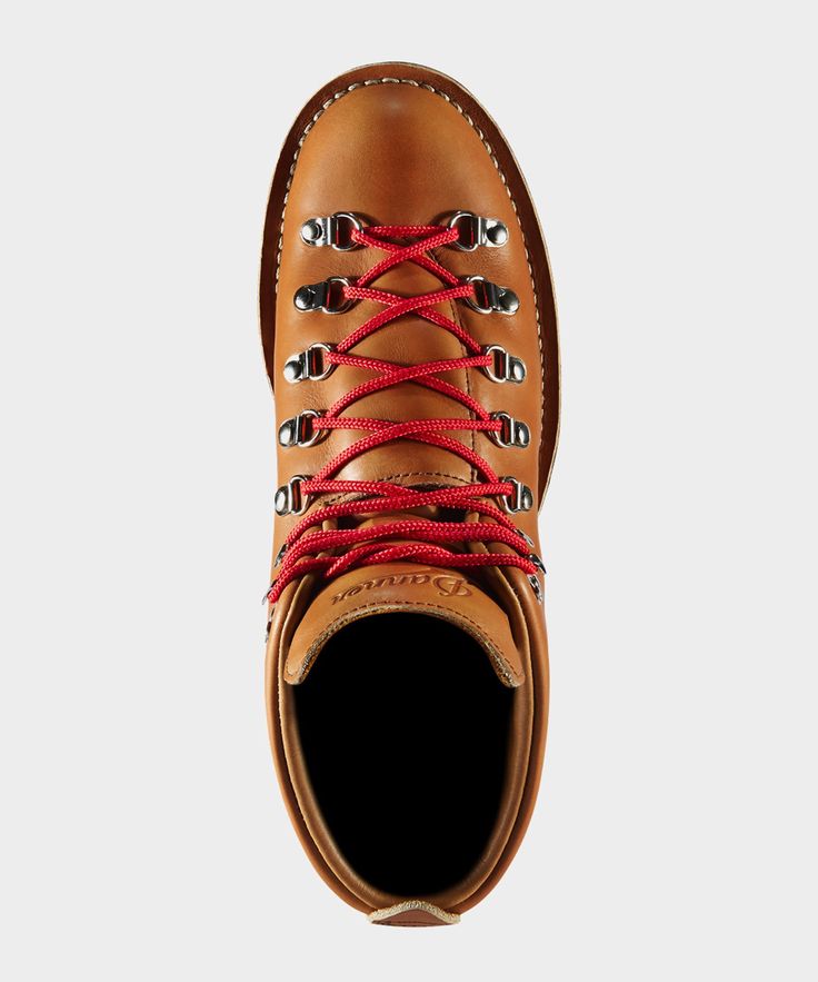 a pair of brown boots with red laces