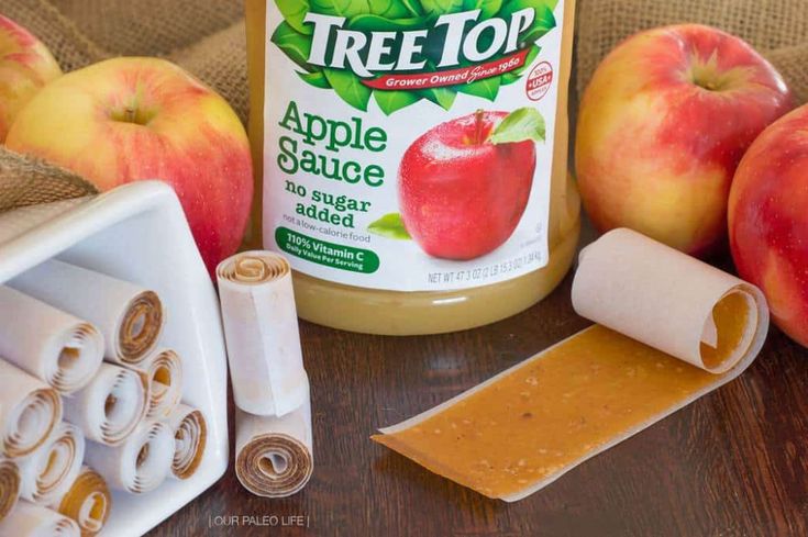 an apple sauce is sitting on a table next to some apples and other items for making it