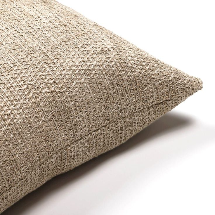 a close up view of a pillow on a white surface with no one around it