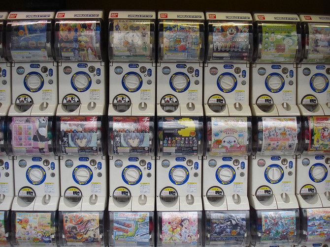 a bunch of wii remotes stacked on top of each other in a display case