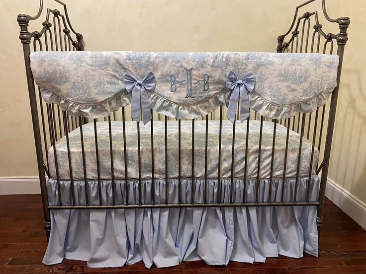 a baby crib with blue and white bedding