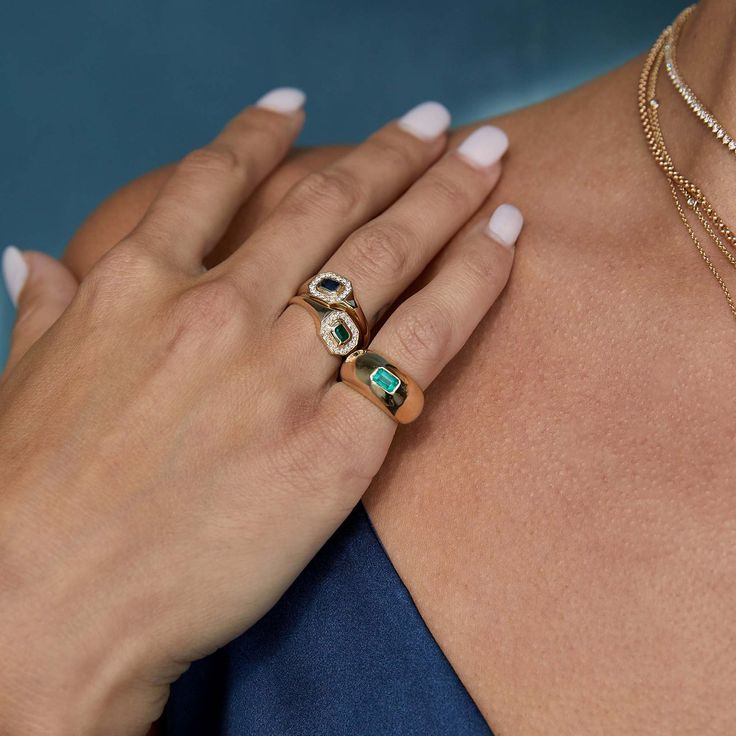 a woman's hand with two different rings on her shoulder and one holding the other