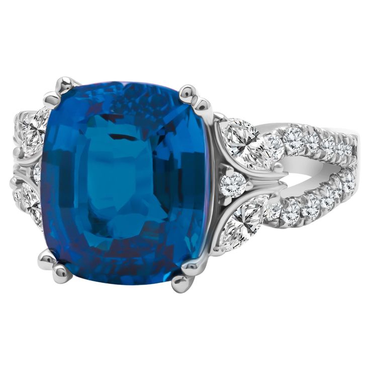 This exquisite ring showcases a 12mm by 10mm Oval Cut London Blue Topaz at its center, elegantly perched atop a beautifully hand-engraved milgrain setting. Adding to its charm, the side shank boasts a delicate butterfly design, crafted from marquise and round-cut white diamonds. The total center weight is 6.37 carats. The total diamond weight including marquise and round white diamonds is 0.78 carats. Set in 14k White Gold At DiamondTown, we take immense pride in presenting our extensive range of exquisite fine jewelry, thoughtfully curated to cater to all preferences and adorned with a delightful array of gemstones. What's even more exciting is that many of our exceptional pieces come with complementary companions. We invite you to explore our diverse collection by browsing our other list Delicate Butterfly, London Blue Topaz, London Blue, Butterfly Design, White Diamonds, Hand Engraving, Cocktail Rings, Oval Cut, Diamond White