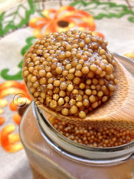 a wooden spoon with some food in it on top of a jar filled with water