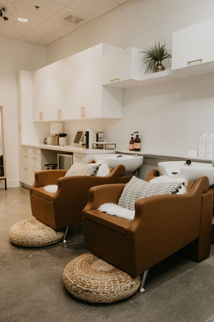 two brown leather chairs sitting next to each other