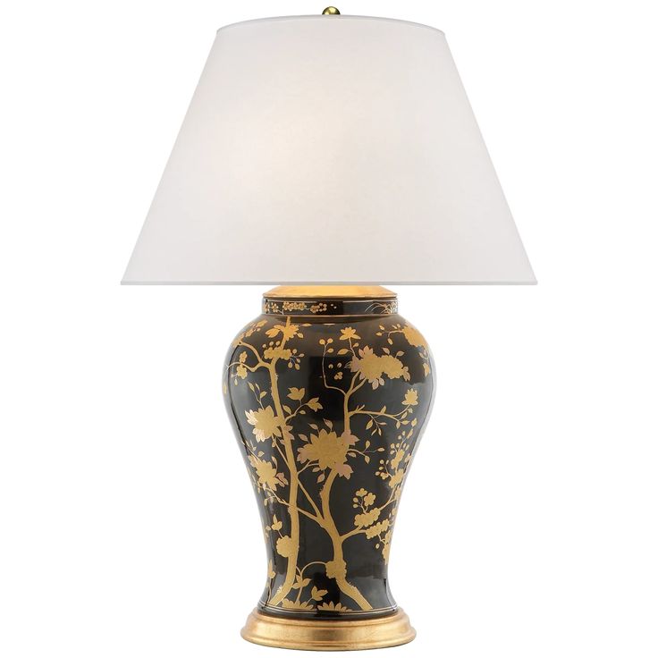 a black and gold vase lamp with a white shade on the top, against a white background