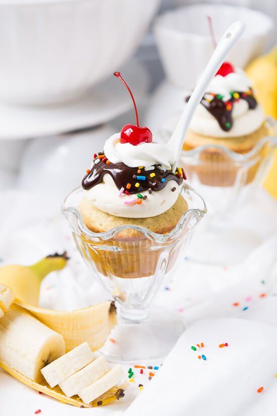 banana split cupcakes with chocolate frosting and sprinkles on top