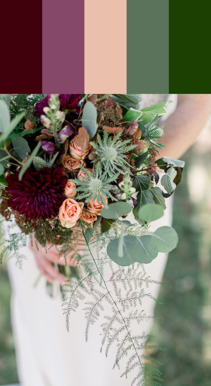 a woman holding a bouquet with flowers and greenery