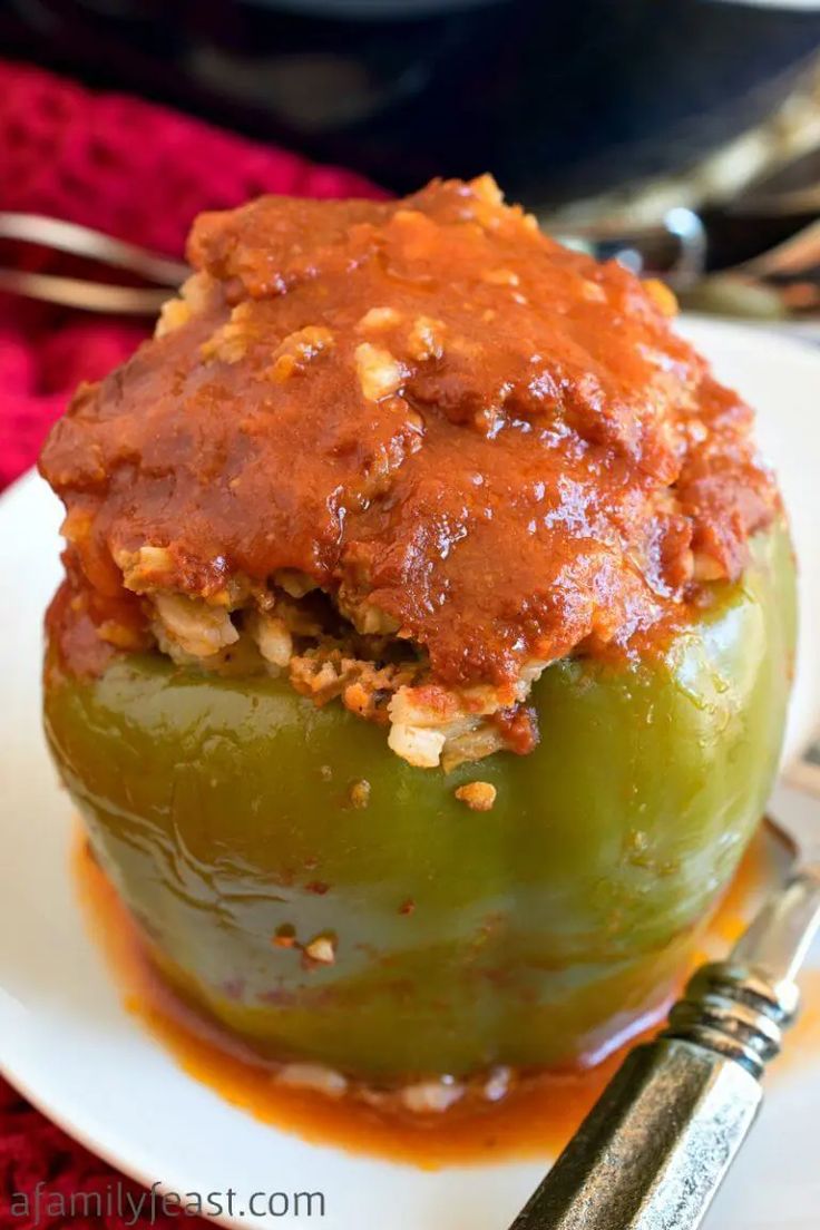 the stuffed peppers are covered in sauce and ready to be eaten on the table for dinner