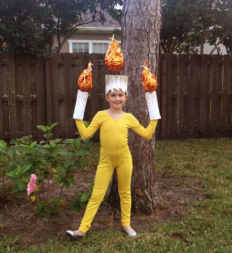 a young boy dressed in yellow holding up two plastic cups