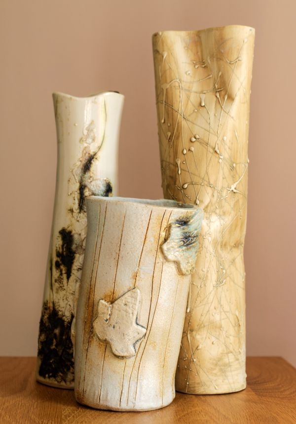 three vases sitting on top of a wooden table