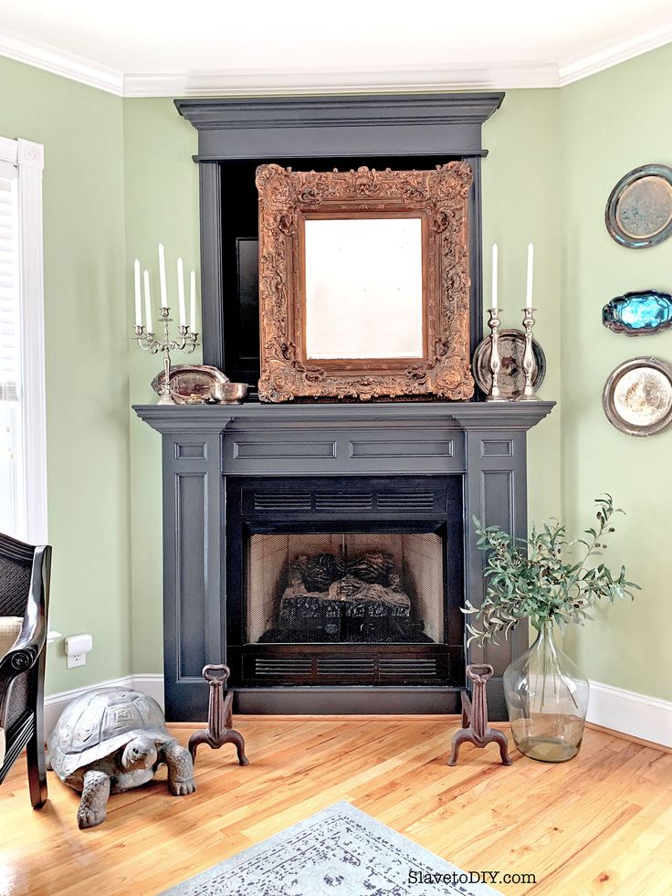 a living room filled with furniture and a fire place in front of a mirror on the wall