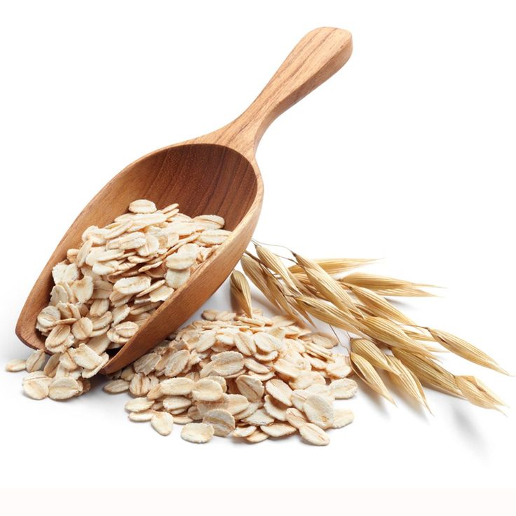 oatmeal and wooden spoon on white background