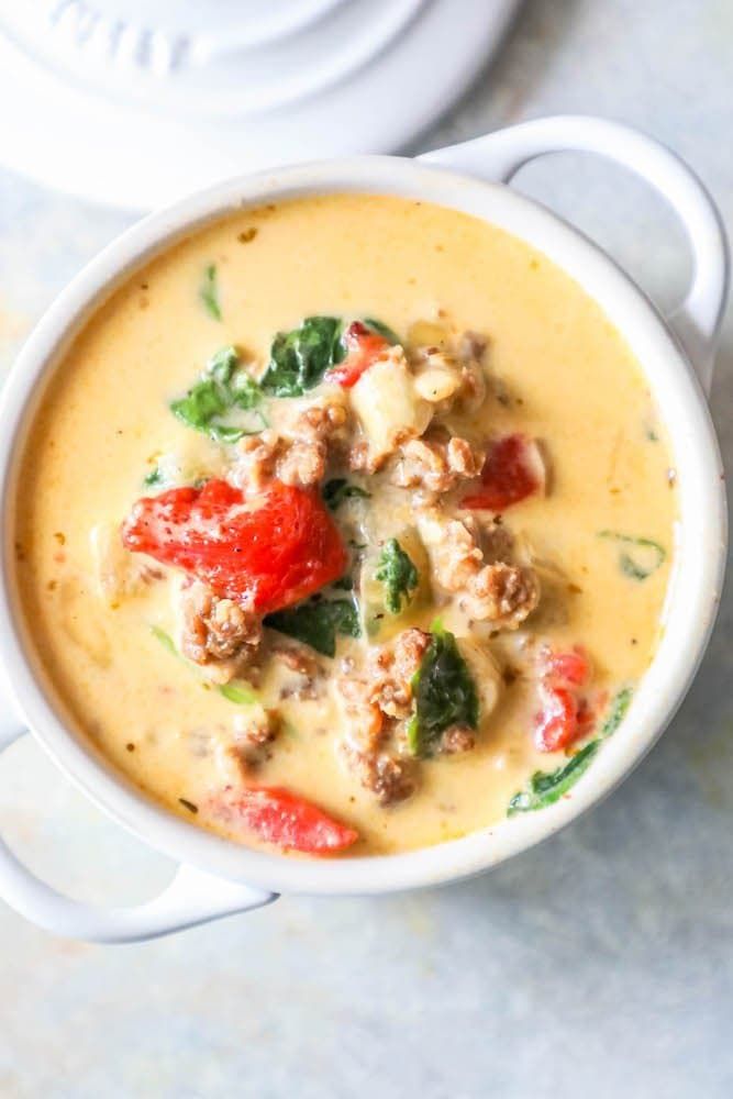 two white bowls filled with soup on top of a table