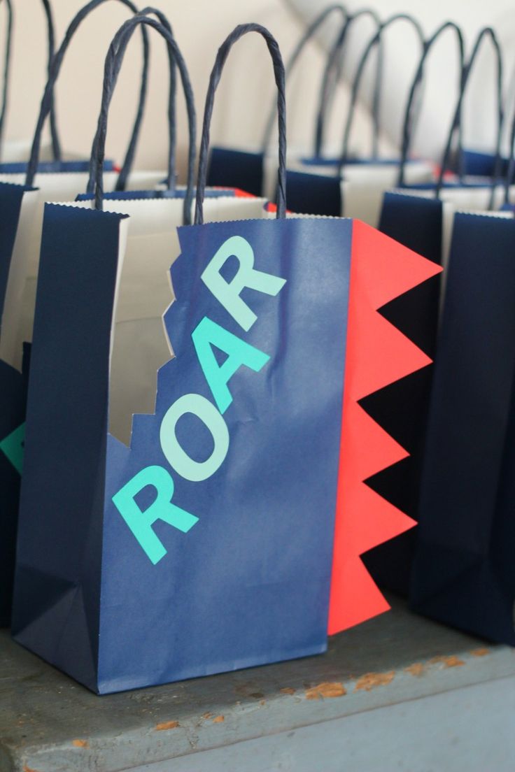 paper bags with the word roar printed on them are lined up against each other in different colors