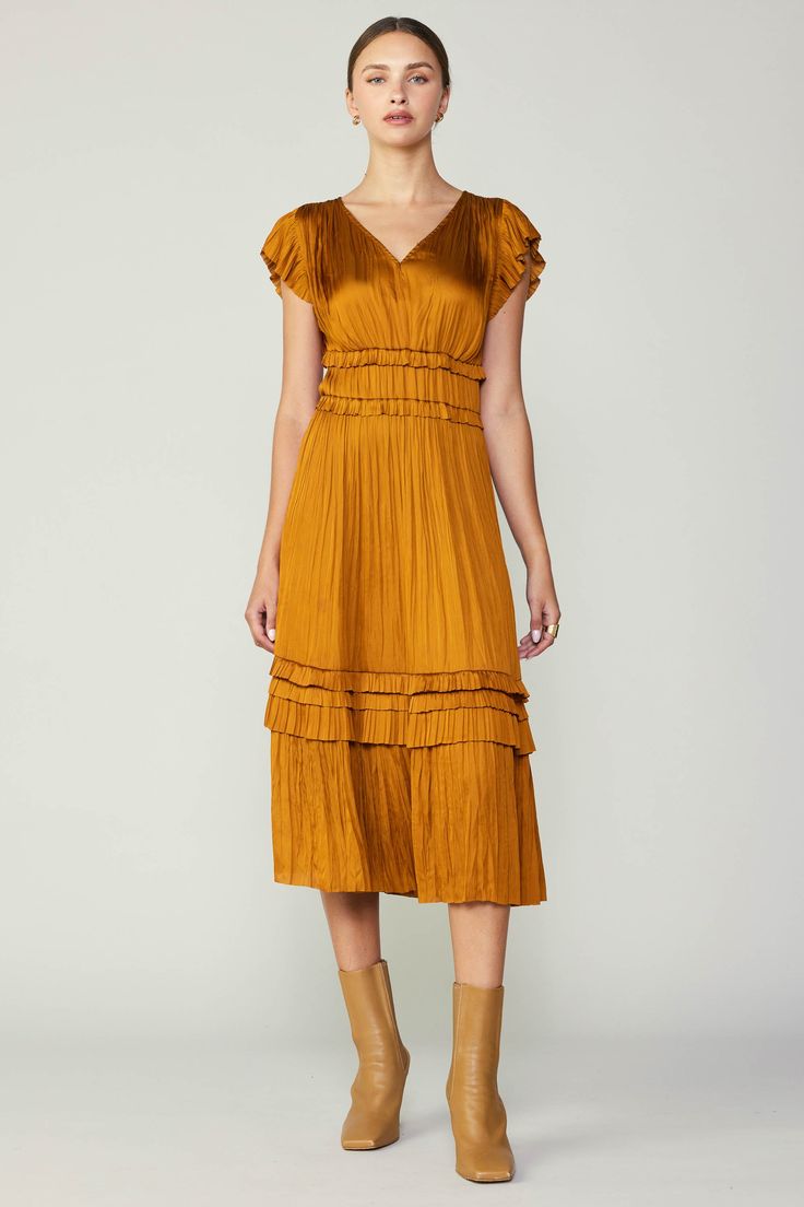 Allover pleating, fluttery cap sleeves, and sweet ruffle accents deliver a decidedly feminine look to this V-neck midi dress in a beautiful golden shade. A go-to for date night or daily wear easily paired with any second layer of your choosing. On Average, customers say this style runs large SMALL BODY LENGTH - 46" •Ir Ruffle Long Dress, V Neck Midi Dress, Pleated Midi Dress, Feminine Look, Ruffle Trim, Midi Length, Cap Sleeves, Daily Wear, Wedding Guest Dress