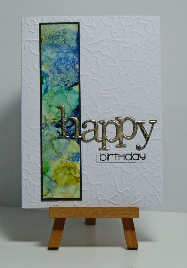 a happy birthday card on a easel with the word happy written in gold letters