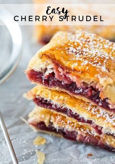 three cranberry strudel stacked on top of each other with powdered sugar