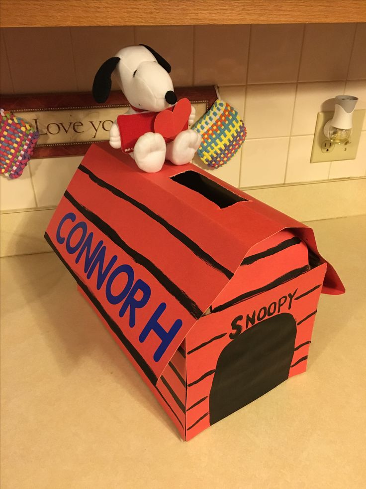 a snoopy dog in a box on the kitchen counter