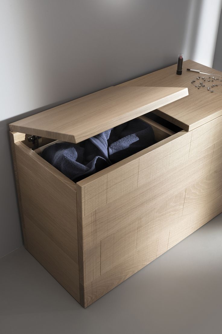 an open wooden box with clothes in it